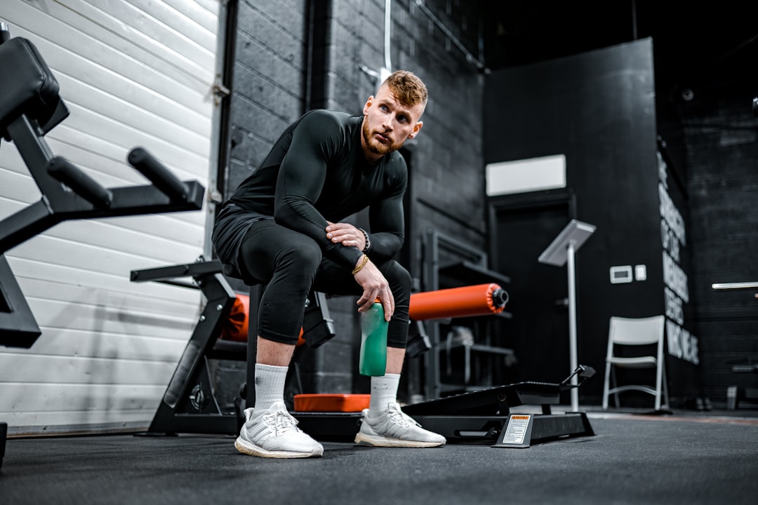 A person stretching or using a foam roller in a home or office setting, symbolizing fitness recovery amidst a busy lifestyle.