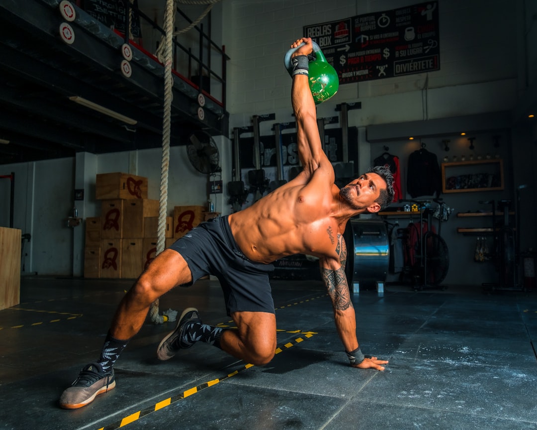 A person stretching after a workout in a gym setting, focusing on recovery and relaxation.