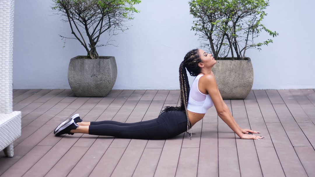 A person performing a simple stretching exercise in a serene environment, showcasing flexibility and relaxation.